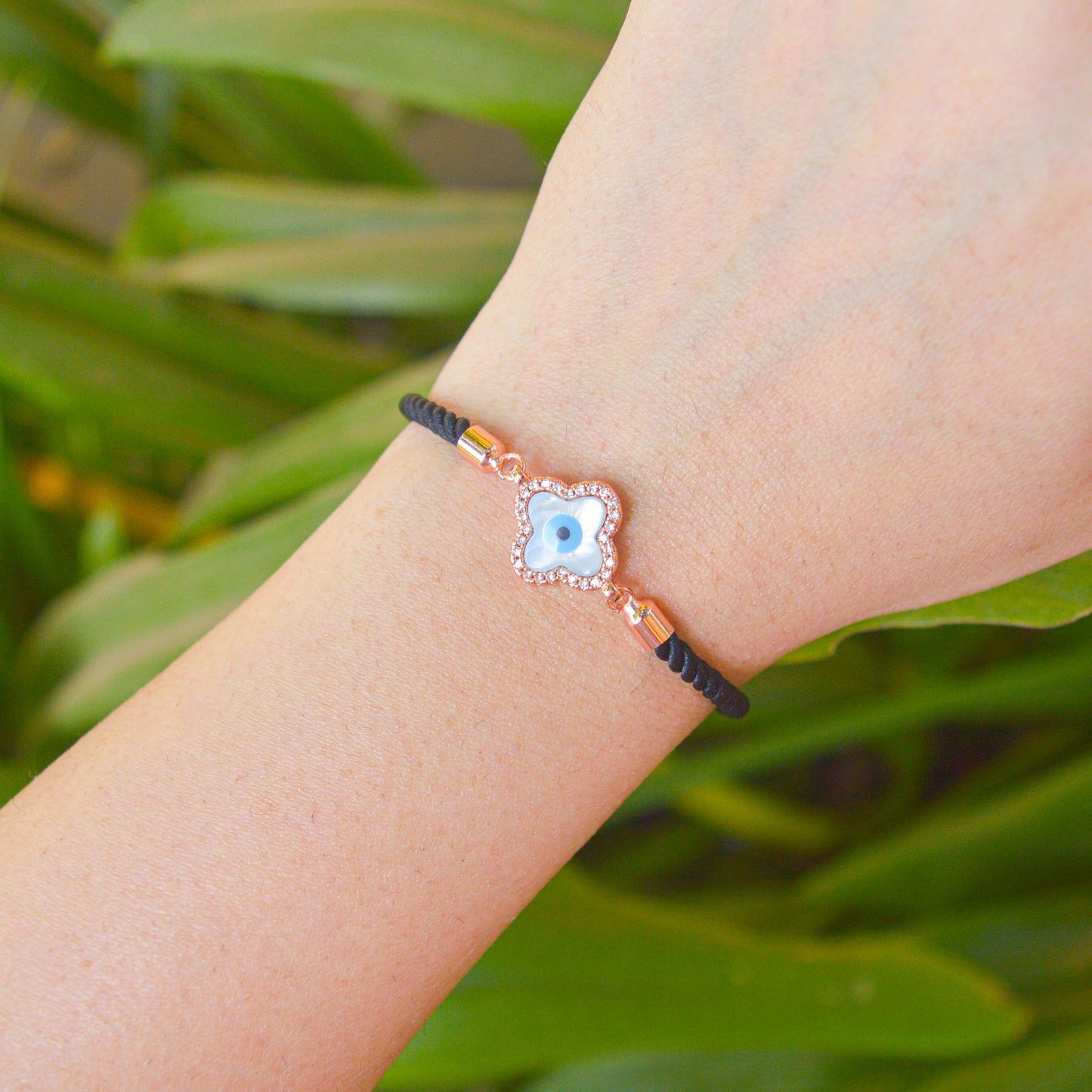 Clover Pearl Studded Evil Eye Black Band Bracelet ( Rose Gold)
